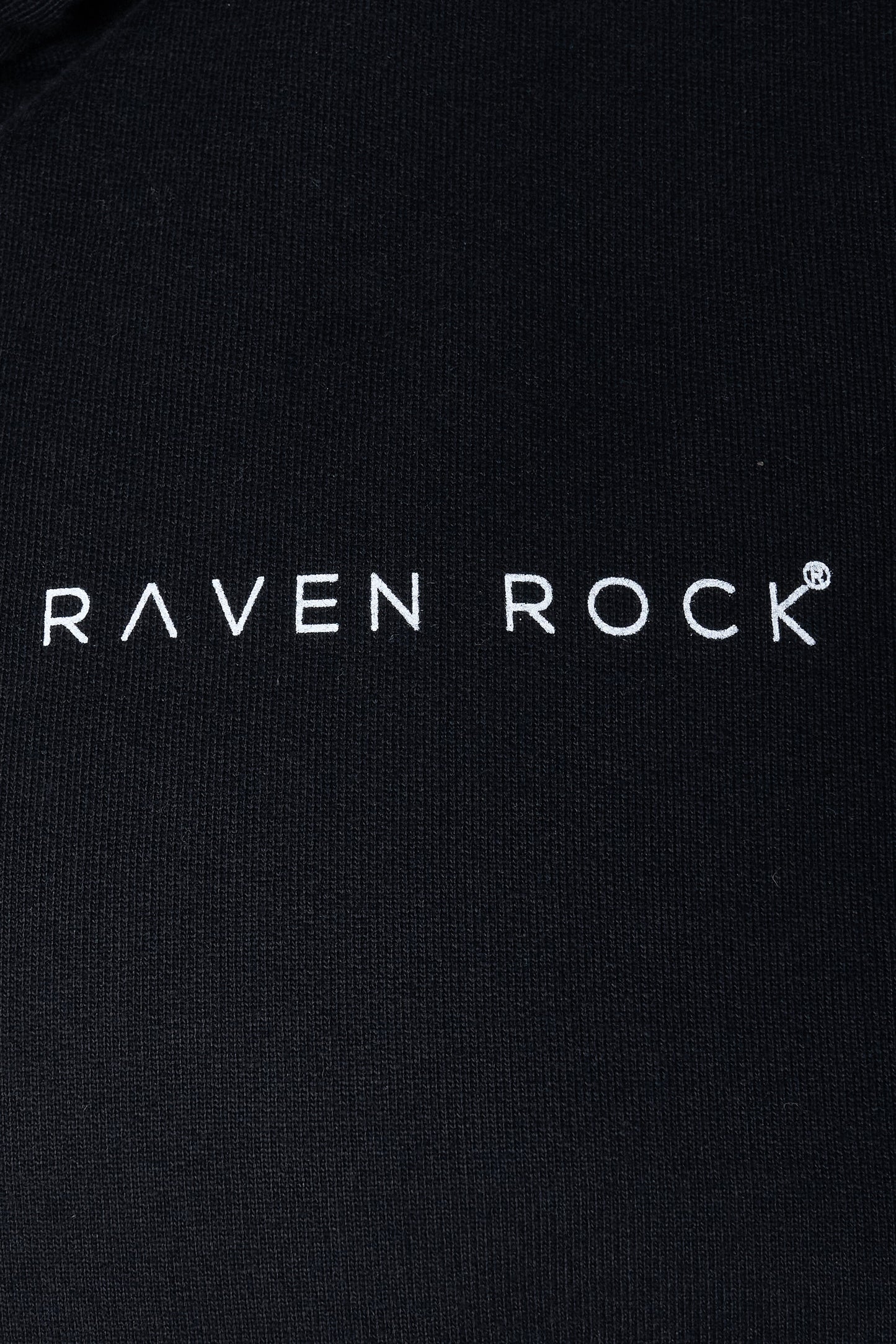 Close-up of RAVEN ROCK logo print on black hoodie – traceable cotton, made in Britain