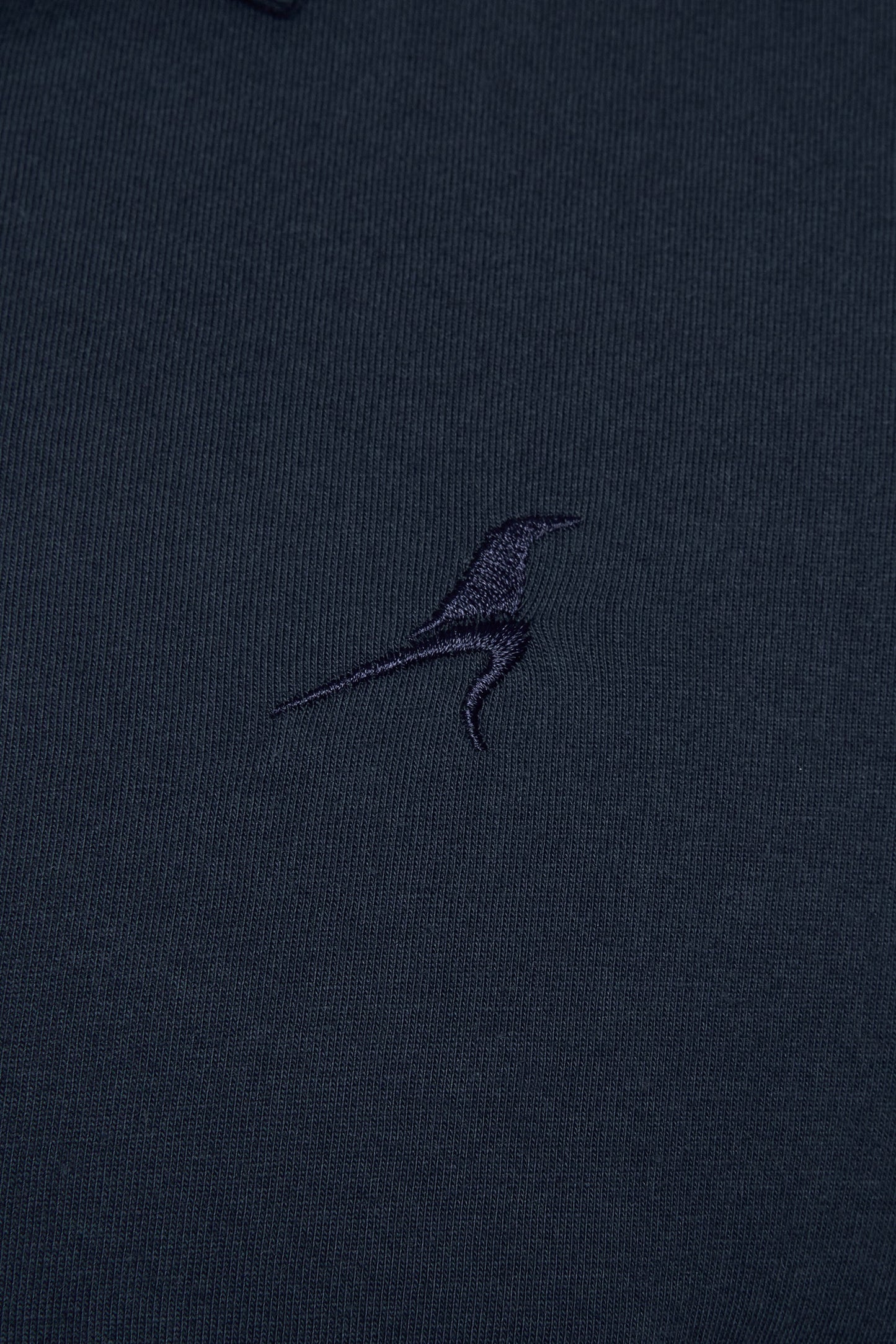 Navy blue shirt with a small embroidered logo