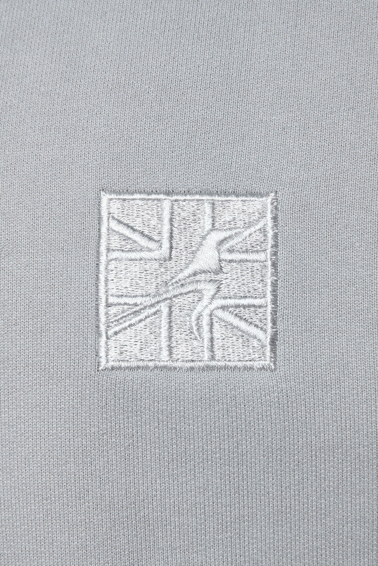 Embroidered grey logo on a grey hoodie