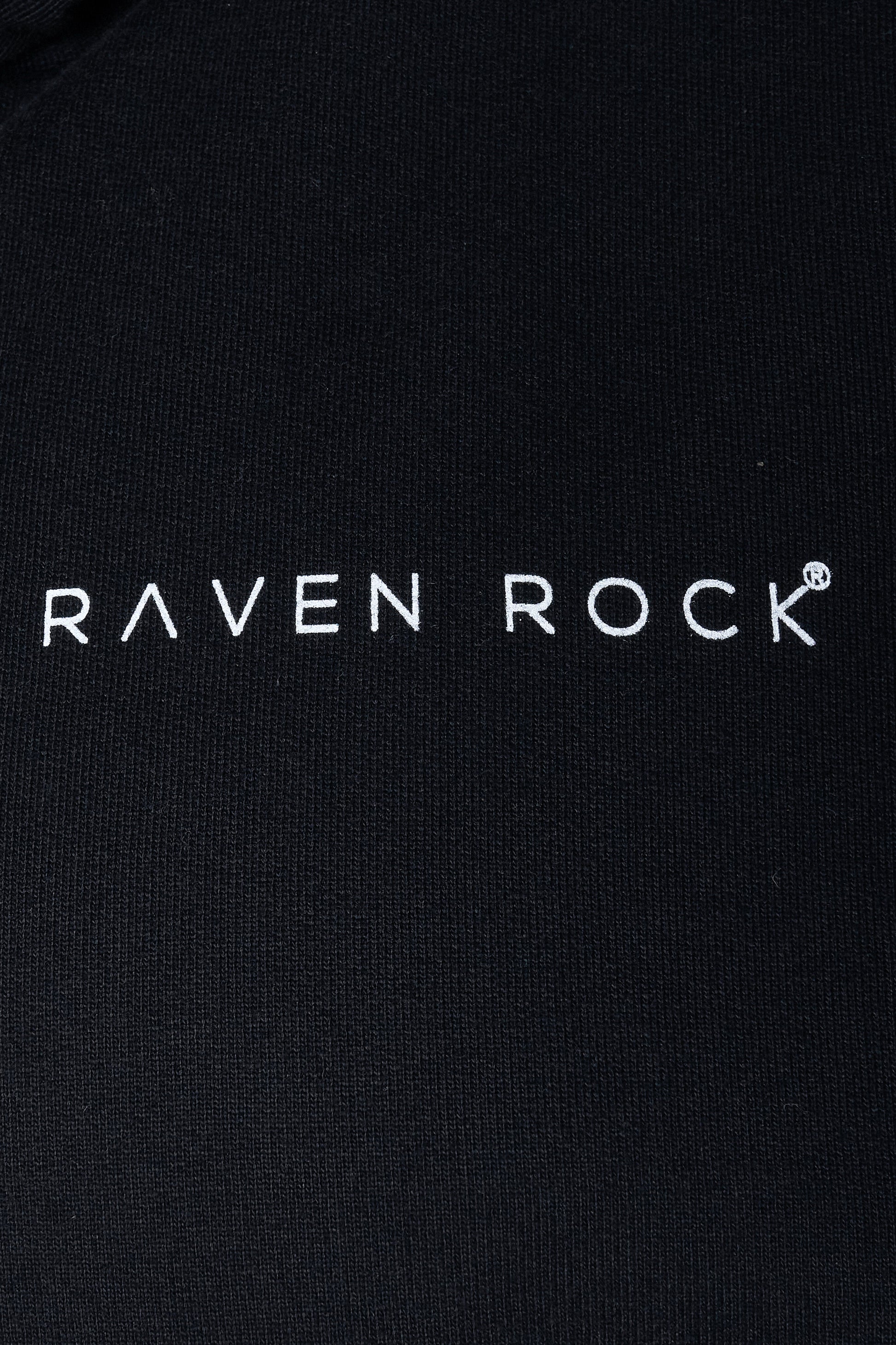 Close-up of RAVEN ROCK logo print on black hoodie – traceable cotton, made in Britain