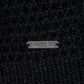 Close-up of a black wool yarn with RAVEN ROCK metal tag 